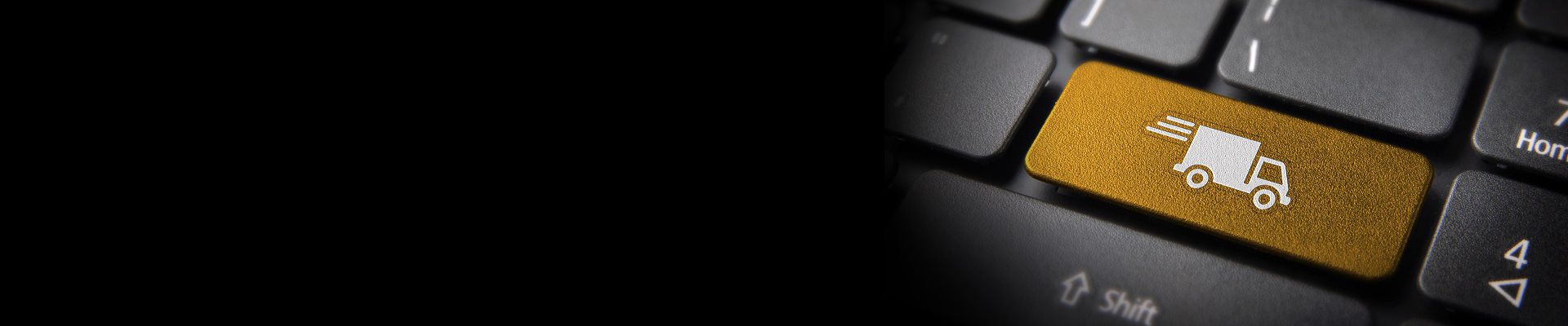 Computertastatur mit einer gelben Taste und weißem Motiv eines Transporters